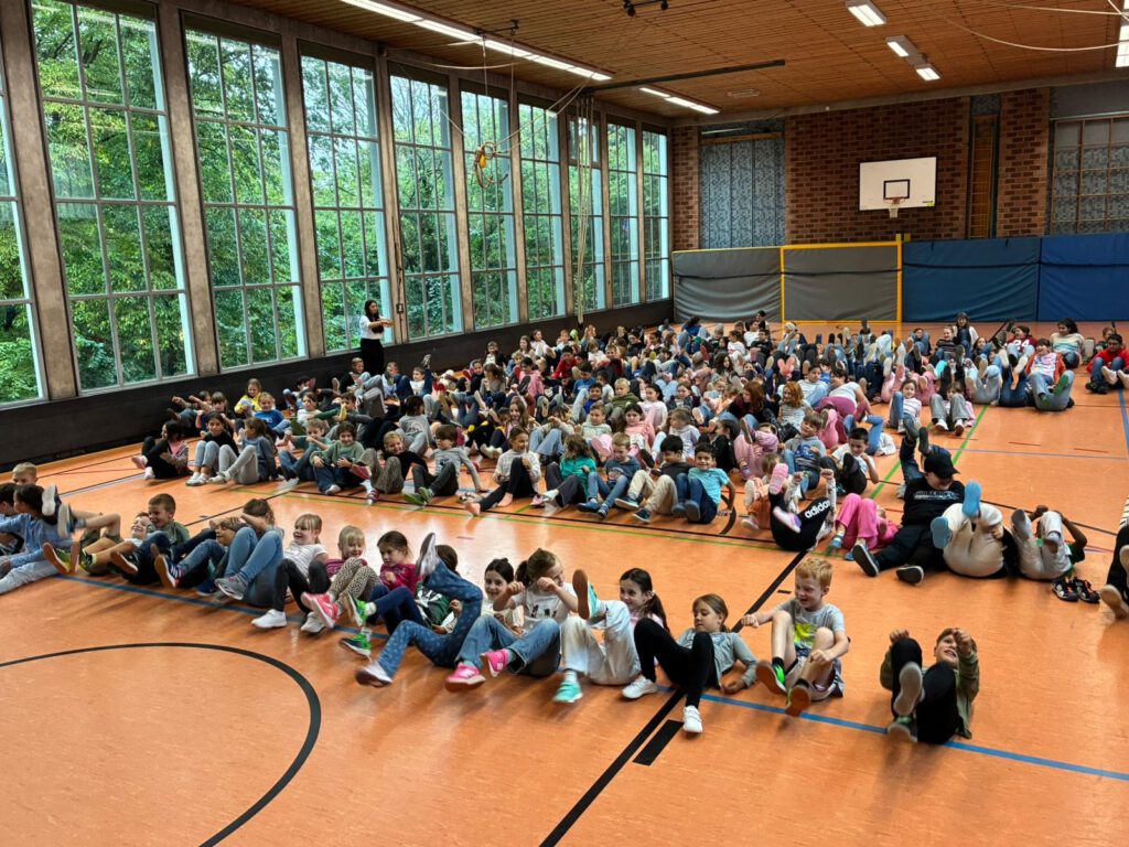 Kinder radeln in der Turnhalle